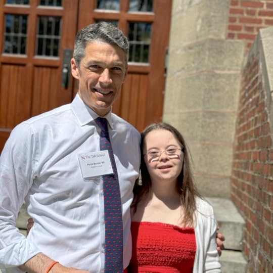 Peter, in a white shirt and tie, standing next to Penny, in a red dress