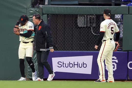 San Francisco Giants’ Luis Matos is examined after he crashed...