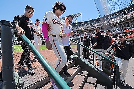 San Francisco Giants’ Jung Hoo Lee (51) is escorted to...
