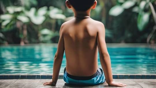 Boy sitting on pool edge