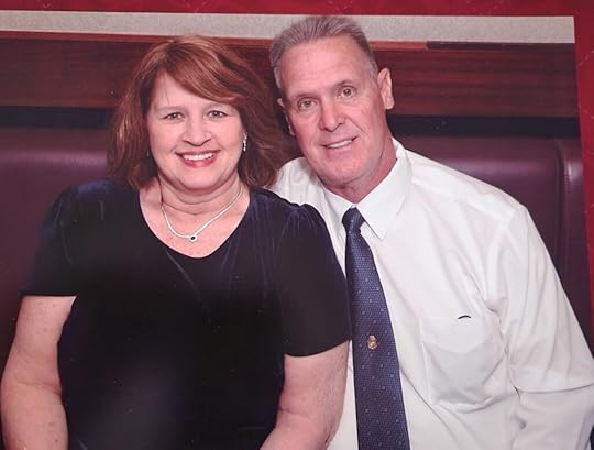 A man wearing a tie with his wife