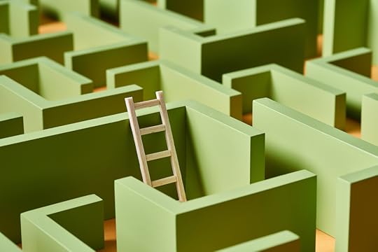 Small escape ladder leaned to green wall of mockup of maze.