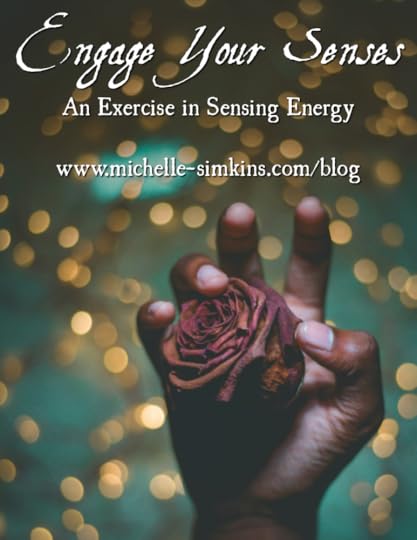 A hand holding a dried rose with blurred lights in the background and the words 