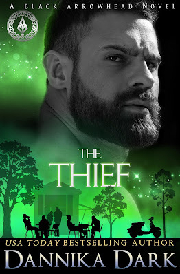 Tough bearded man staring over his shoulder with silhouette of outdoor diners and green background