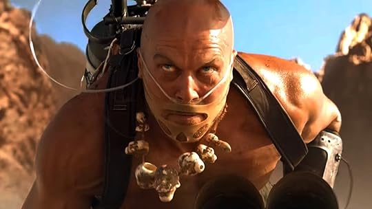 A shirtless Rictus Erectus looks mean atop a movie car in Mad Max: Fury Road