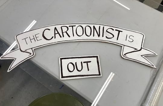 Two hand-lettered signs that say "the cartoonist is out."