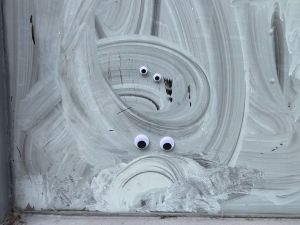 eyes stuck on a whitewashed window to make it look like two miserable faces