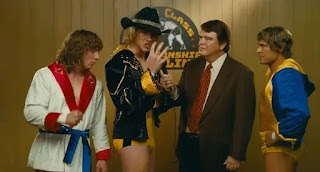 Still from the movie with wrestling brothers Von Erich on a sports show