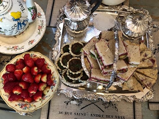 An overhead view, showing the Alice in Wonderland teapot, strawberries, the tea set, the mushroom tarts, sandwiches, and scones.