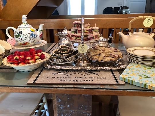 A view of the whole spread: Alice in Wonderland teapot, strawberries, tarts, sandwiches, scones, a second teapot, and fancy saucers, teacups and napkins. God I'm extra.