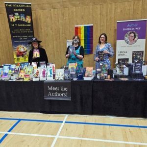 Picture of authors at a table selling their books
