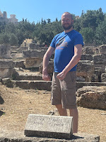 Silly man posing at sign saying House of Simon