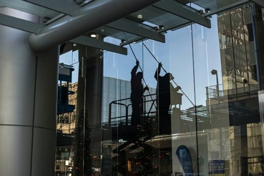 People cleaning windows of a high-rise building. Like positivity, easier said than done