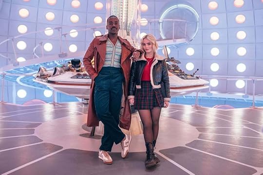 Ncuti Gatwa as the Doctor and Millie Gibson as Ruby Sunday, standing in the new TARDIS control room, a cavernous space with ramps and walkways and glowy roundels all over the walls, with a hexagonal control console behind them