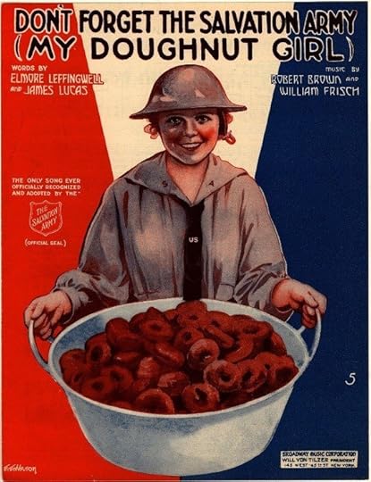 Four women standing side by side against a black background. From left to right: the first woman has white hair, wears a navy blue blazer over a beige pair of pants, and has a red scarf with white polka dots tied at her neck. The second woman has light gray hair, wears a navy blue blazer with red details and a matching red scarf with white polka dots, and sports a button on her lapel. The third woman has brown hair, is wearing a black coat over a patterned shirt, and her posture suggests she may be in mid-motion. The fourth woman has red hair, wears a black and white patterned blazer over black pants, and has her arm linked with the third woman. 