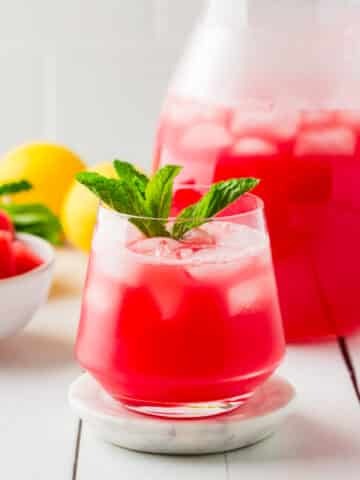 Watermelon Lemonade in a glass with mint on top.