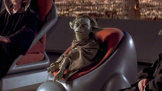 Yaddle from star wars phantom menace sits in a chair