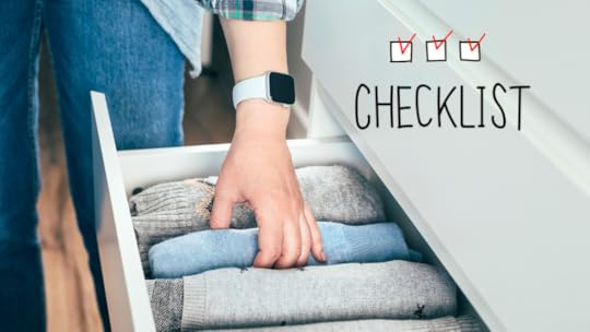 An image of a person organizing her clothes using a minimalist checklist.