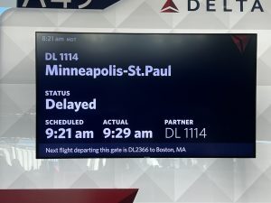 Airport sign showing delayed flight
