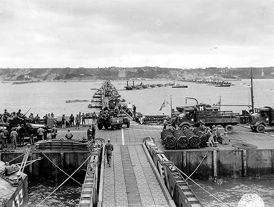 Military vehicles move ashore from Mulberry Artificial Harbor A, across a pontoon bridge, to Omaha Beach, Normandy, June 16 1944 (US National Archives)