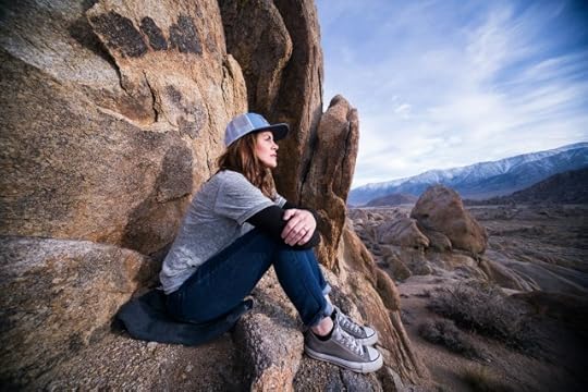 woman sitting on a ledge looking out. gratitude, mindfulness, and positivity