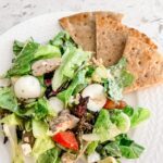 The finished Greek Inspired Chicken Cobb Salad with pita slices