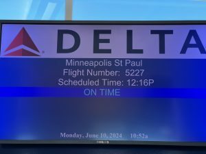 Picture of the departure board showing a 12:16 departure time.