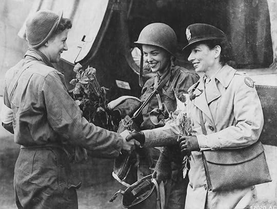 Flight nurses Lt. Suella Bernard and Lt. Marijean Brown, the first nurses to evacuate the wounded from Normandy to England, are greeted by their head nurse, Lt. Foster. (US Air Force photo: AC 52020)