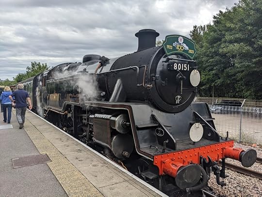 A black steam locomotive, 80151, waiting at its platform.