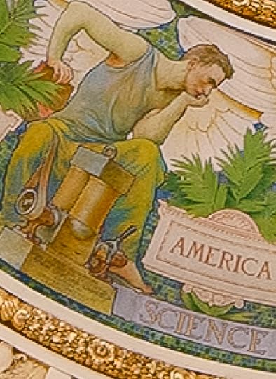 An extreme close up shows of the mural shows a muscular young man in a tank top, work pants and bare feet, chin on his left palm, studying a small mechanical device 