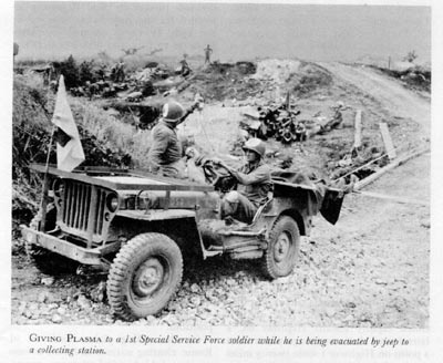 US medics administer plasma to a patient in a jeep ambulance, Italy, 1944 (US Army Medical Dept.)