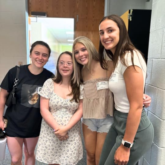 Penny poses with three friends who are in college who came to watch her presentation.