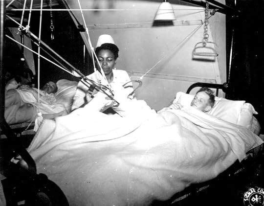 African-American US Army nurse Lt; Florie E. Gant tending a prisoner-of-war patient, England, 7 Oct 1944 (US National Archives: 112-SGA-Nurses-44-1676)