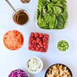 array of salad bar items on white counter.