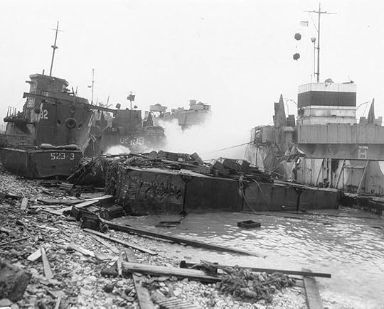 Broached landing craft during the Normandy storm, probably at Omaha Beach, 21 June 1944; USS LST-543 in background (US National Archives: SC 193919)