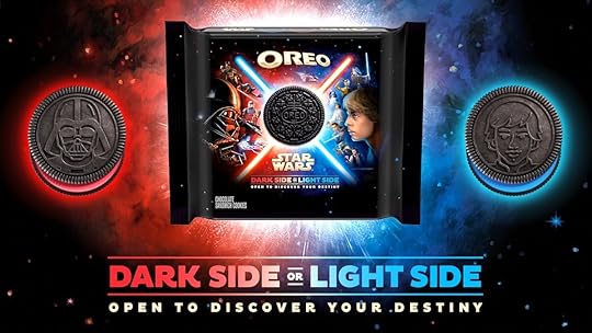 A box of Oreo Star Wars cookies with character art on the package and red and blue lit cookies on the outside above writing