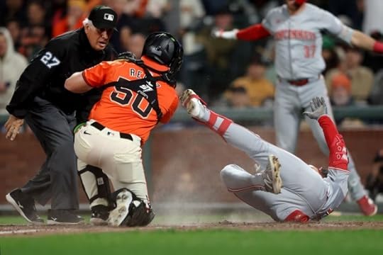 Cincinnati Reds's Stuart Fairchild scores on an inside-the-park home run in the 8th inning against the San Francisco Giants catcher Jakson Reetz, Friday, May 10, 2024, at Oracle Park in San Francisco, Calif. Homeplate umpire Chris Segal makes the call (Karl Mondon/Bay Area News Group)