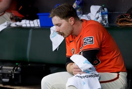 San Francisco Giants's Austin Slater #13 holds his left elbow in the dugout after crashing into the outfield fence chasing a ball hit by Cincinnati Reds' Spencer Steer in the first inning, Friday, May 10, 2024, at Oracle Park in San Francisco, Calif. (Karl Mondon/Bay Area News Group)