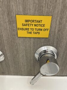 Sign on a bathroom wall that says,