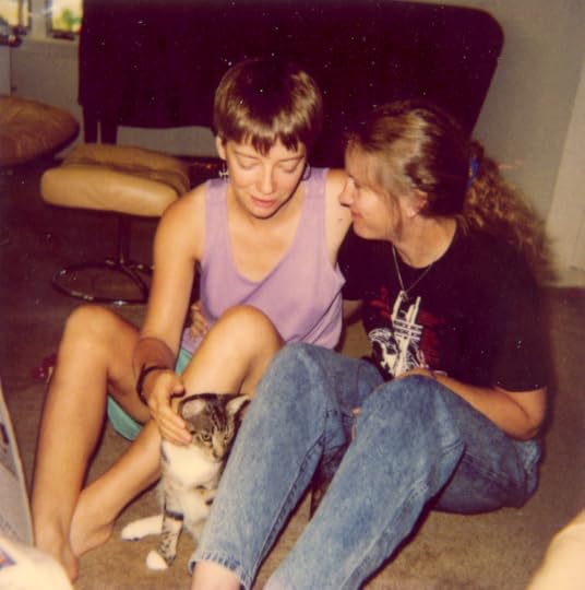 Nicola and Kelley—with short and longn fair hair respectively looking about two years ago and hopelessly in love, gazing at each other and also adoring a small cat