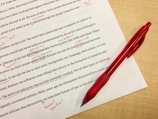 A manuscript page with edits done in red pen