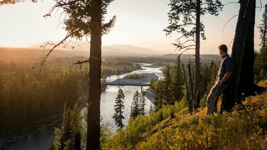 man leaning on a tree overlooking a river valley. reason is the true opposite of fear