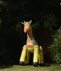 Playful giraffe statue