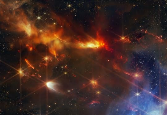 An image of the Serpens Nebula, taken by the James Webb Space Telescope. Fiery gases burn in the darkness of space, like a great dragon soaring through the night.