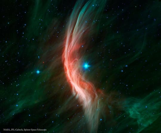 An image of the 'runaway star' Zeta Oph, taken by the Spitzer Space Telescope. A huge red curve of gas carves through space.