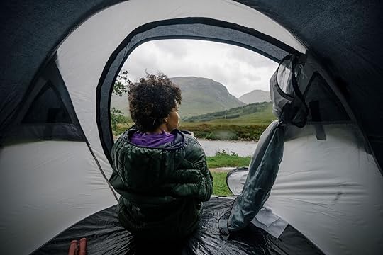 woman rain camping in tent - hipcamp weather guarantee