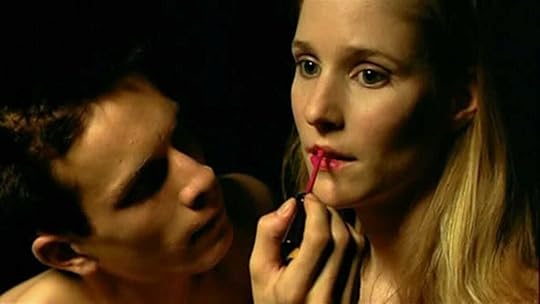 Jérémie Renier applies lipstick to Natache Régnier in