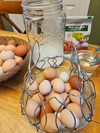 baskets of eggs and jar, pickling lime and water set up to make water glassed eggs