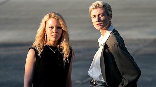 Mia Goth as Maxine Minx stands with Elizabeth Debicki in MaXXXine