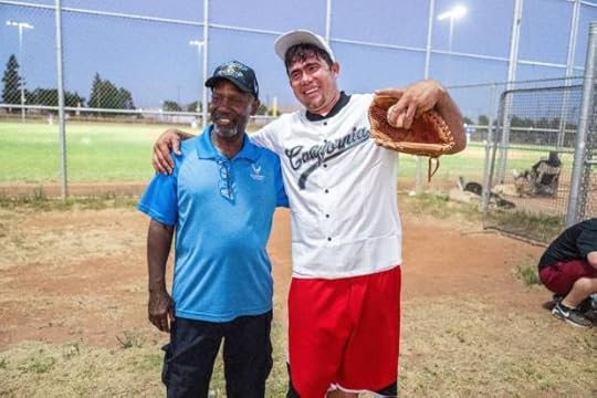 Dionisio Holmes stands with Jorge Gil Laguna, one of the immigrants that was flown to Sacramento last year, as he attends a tryout for the Sacramento Men's Senior Baseball League earlier this month. Holmes, who was born in Panama, helped Laguna get placed on the team. (Hector Amezcua/The Sacramento Bee/TNS)